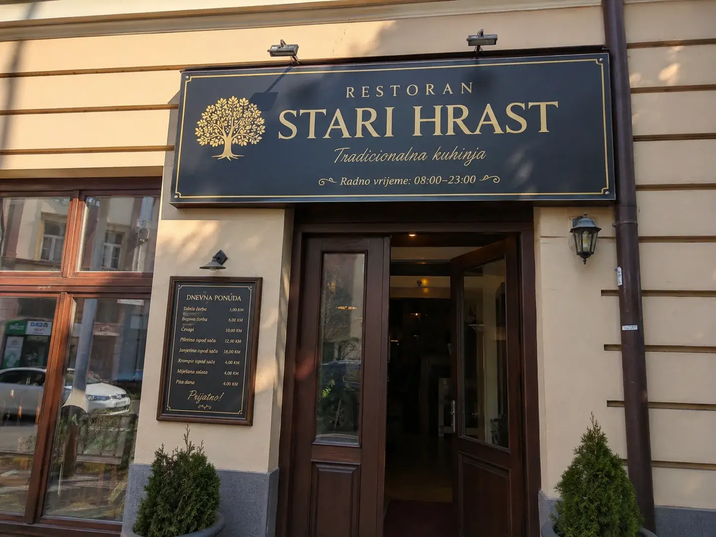 Restoran sa iverit tablom iznad ulaza sa nazivom brenda